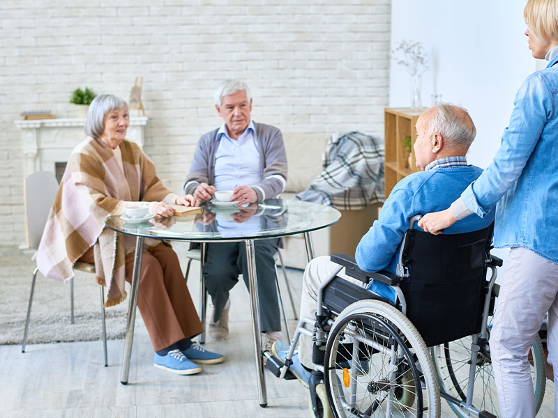 caretaker pushing senior man in wheelchair at assited living hospital medicare plan a columbus oh