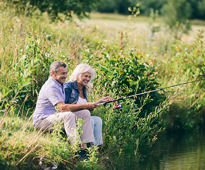 smiling couple fishing by a creek medicare options colulmbus oh